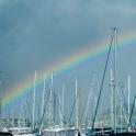 rainbow over yachts in a marina