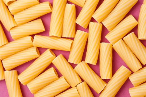 Overhead view of hollow dried pasta tubes made from durum wheat dough for use as an ingredient in Italian and Mediterranean cuisine