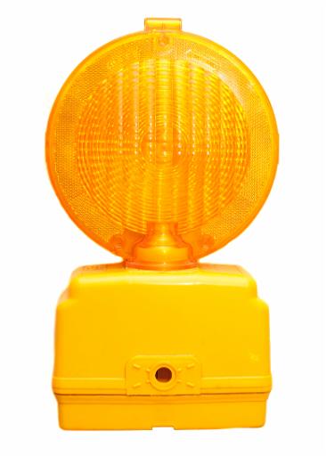 Yellow roadworks light with its own battery pack for warning motorists of construction and maintenance isolated on white